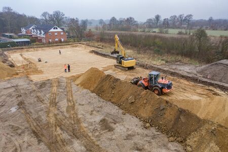 a drone image of a large construction site where the floor is being prepared for a factory building