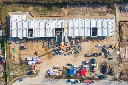 a huge company building is erected on a large construction site