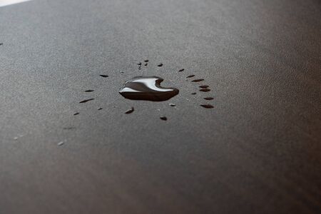 a drop of water has landed on a surface in the shape of a heartの写真素材
