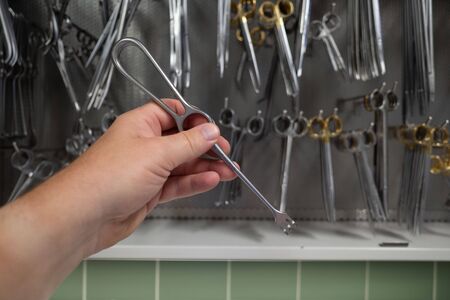 retractor is taken out of the cabinet in a sterilization department