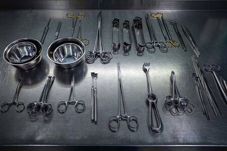 in  sterilization department many cleaned instruments lie on a metal tableの写真素材