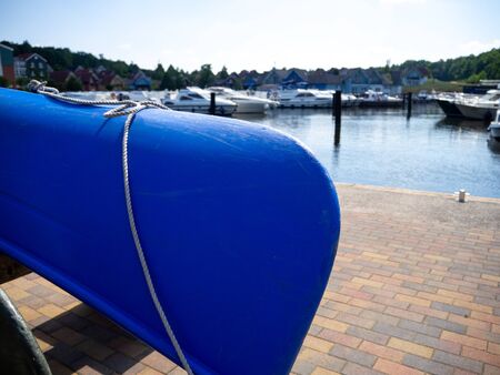 in a harbour many canoes are stacked side by side