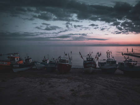 fishing boats at the beach of the Baltic Sea shortly before sunriseの写真素材