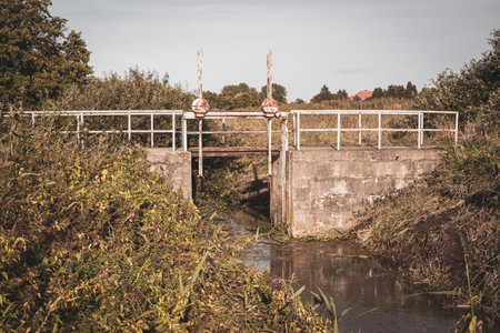 an old rusty lock was used to dam a riverの写真素材