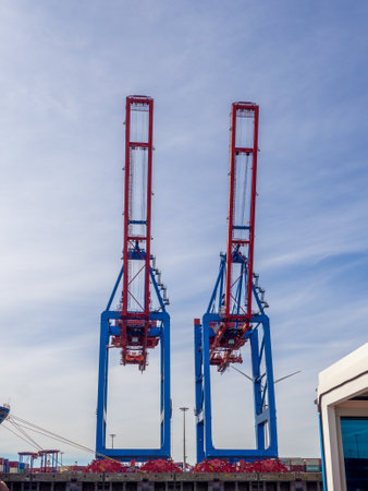 In a port there are cranes for loading and unloading shipsのeditorial素材