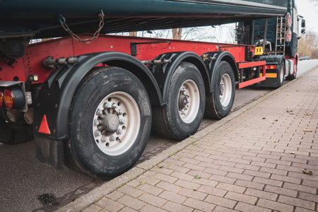 at the roadside a big truck with its big wheels is parked