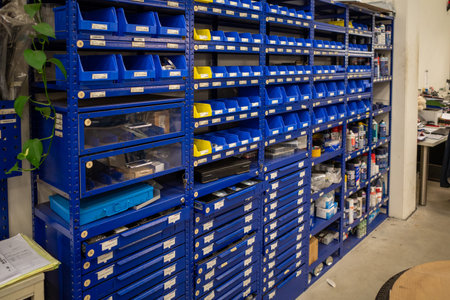 a shelf wall with various spare parts is located in a car workshopのeditorial素材