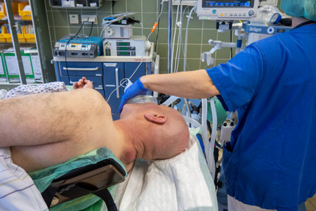 a patient with a large abscess in the neck lying on an operating table to be operated onの写真素材