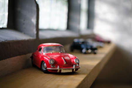 on a windowsill are several vintage model cars