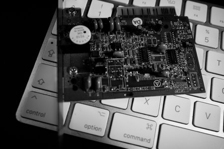 a computer board lies on a white keyboard