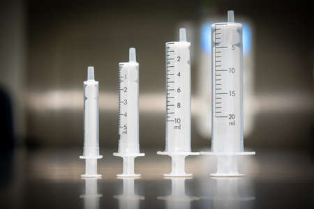 different size medical syringes stand next to each otherの写真素材