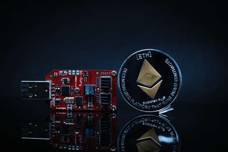 an Ethereum coin stands next to a Bitcoinminer