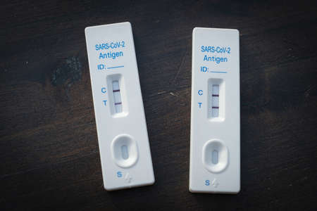 on a table there are two positive rapid tests