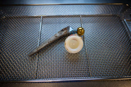 complete explanted hip prosthesis lies in an instrument basket