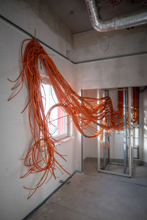 many orange network cables are laid in a new operating theater building