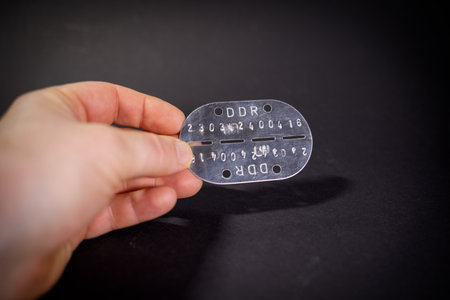 an old military dog tag of the army of the German Democratic Republic