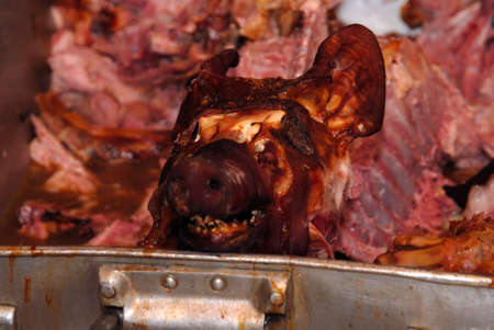 a brown grilled suckling pig lies in a large panの写真素材