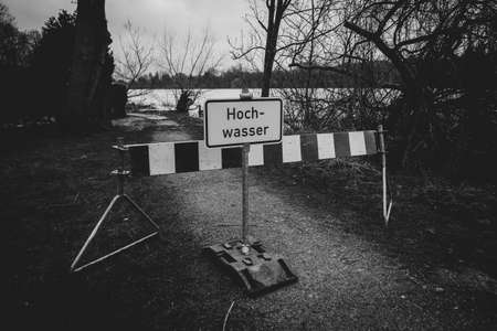 on a flooded path there is a sign with the inscription Flooding