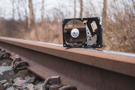 a hard disk stands on the rails of the railroadの写真素材