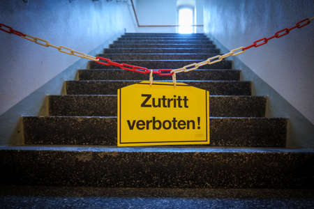 a sign on a chain in front of a staircase says No Entry!の写真素材