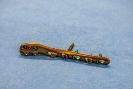 a titanium surgical plate and titanium screws for the treatment of a tibia fractureの写真素材