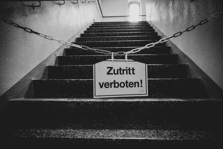 a sign on a chain in front of a staircase says No Entry!の写真素材