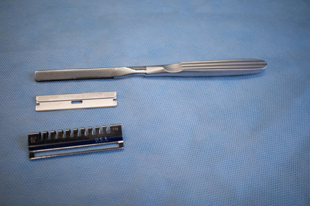 a dermatome knife to remove skin for transplantation