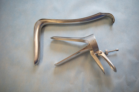 two different types of specula for gynecological examination are next to each otherの写真素材