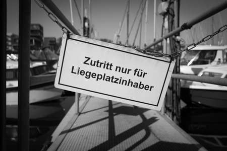 a sign on a jetty says access only for berth holdersの写真素材