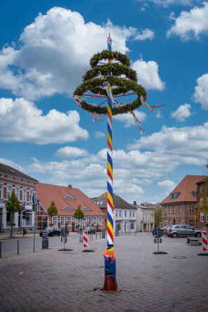 a colorfully decorated maypole stands on a marketplaceのeditorial素材