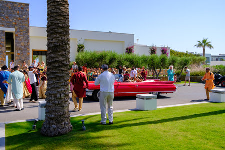 in front of the hotel there is a colorfully dressed indian wedding partyのeditorial素材