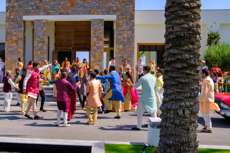 in front of the hotel there is a colorfully dressed indian wedding partyのeditorial素材