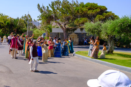 in front of the hotel there is a colorfully dressed indian wedding partyのeditorial素材