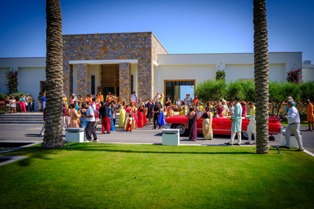 in front of the hotel there is a colorfully dressed indian wedding partyのeditorial素材