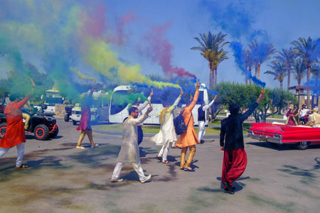 in front of the hotel there is a colorfully dressed indian wedding partyのeditorial素材