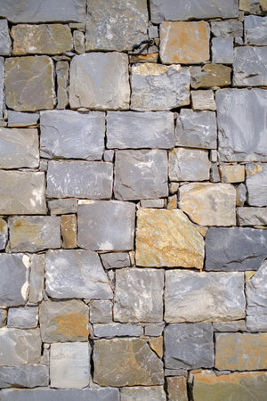 a homogeneous stone wall as backgroundの写真素材