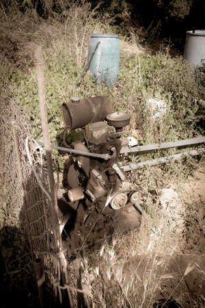 in a garden stands by an old diesel pumpの写真素材