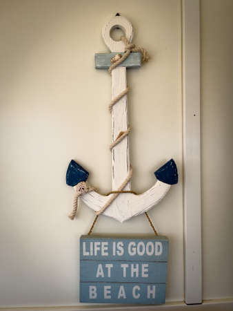 a sign hanging from an anchor says Life is good at the beachの写真素材