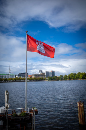 the red flag of Hamburg flies at the Binnenalsterの写真素材
