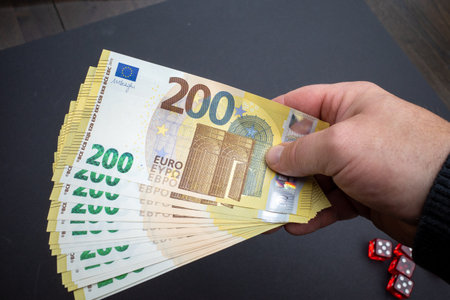 next to the gas meter is held a lot of two hundred euro banknotesの写真素材