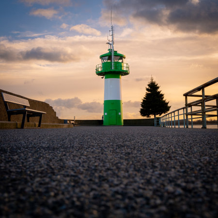 the green-white lighthouse in the harbor of Luebeck Travemuendeの写真素材