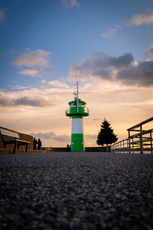 the green-white lighthouse in the harbor of Luebeck Travemuendeの写真素材