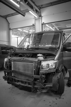 in the car repair shop there is a van whose front was severely damaged by an accidentの写真素材