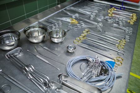 many different cleaned instruments for performing vascular surgery lie on a metal tableの写真素材