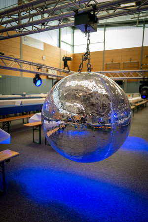 a huge disco ball hangs on a scaffoldの写真素材