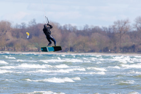 a kitesurfer surfing in stormy weather on the baltic seaの写真素材