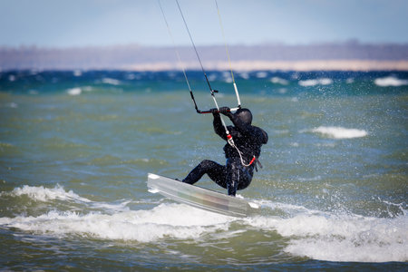 a kitesurfer surfing in stormy weather on the baltic seaの写真素材