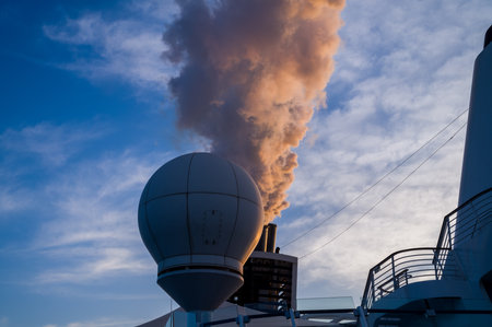 white smoke comes out of the chimney of the cruise shipの写真素材