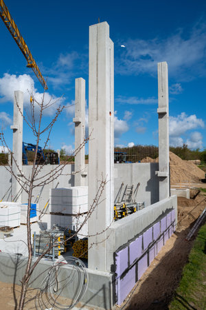 many concrete pillars for a factory building are erected on a construction siteの写真素材