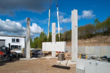 many concrete pillars for a factory building are erected on a construction siteの写真素材